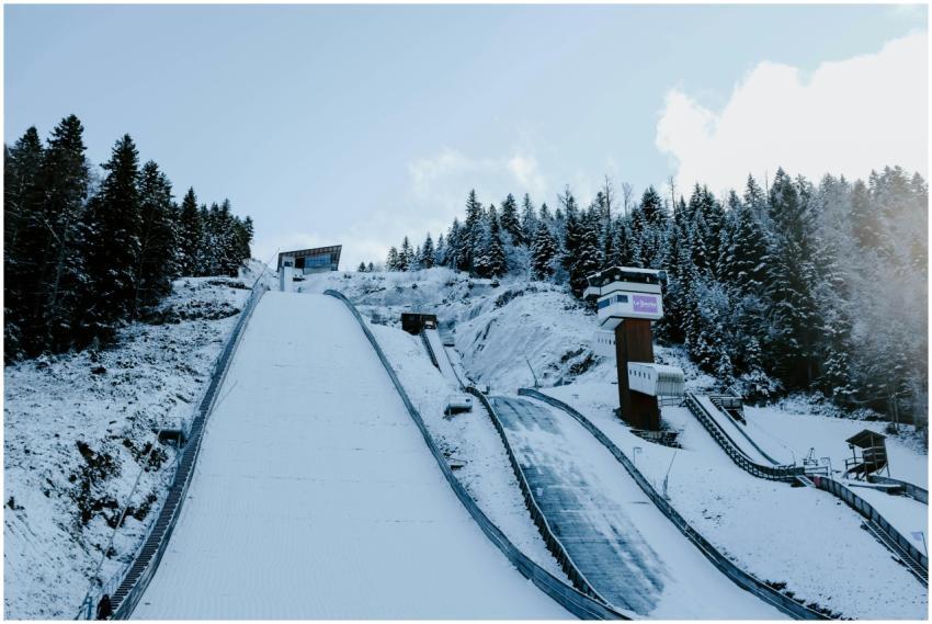 Image of a winter ski jump surrounded by snowy tre