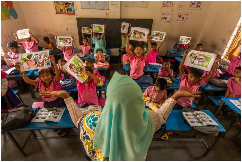 Children in a Bangladesh classroom excitedly displ