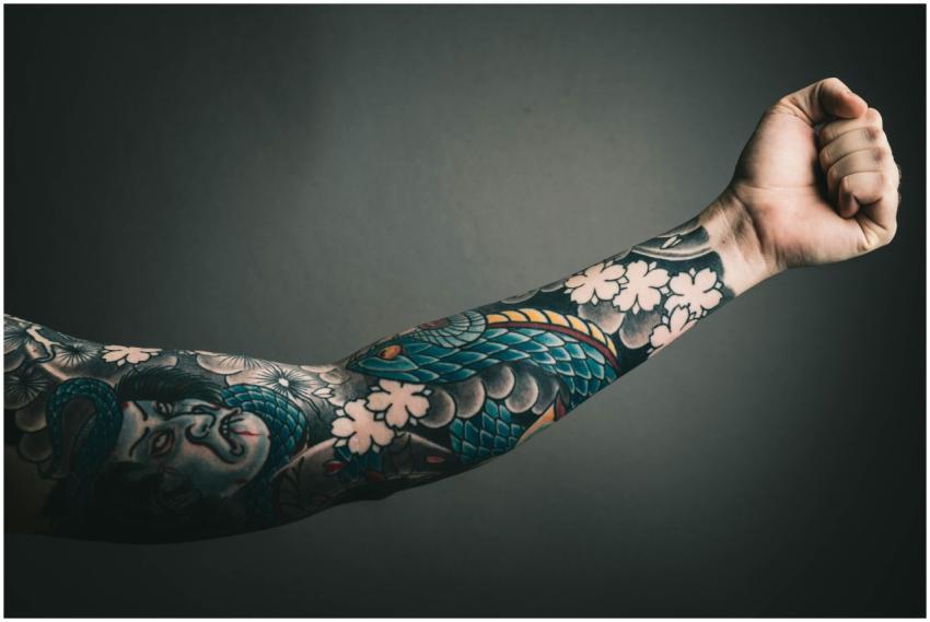 A close-up of a tattooed arm with a colorful sleev