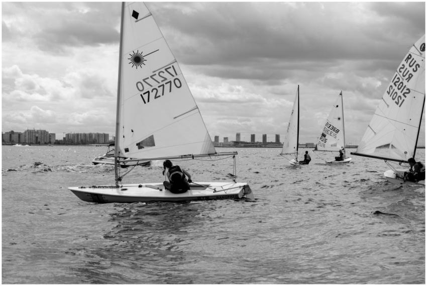 Monochrome photo of a sailing regatta with boats n