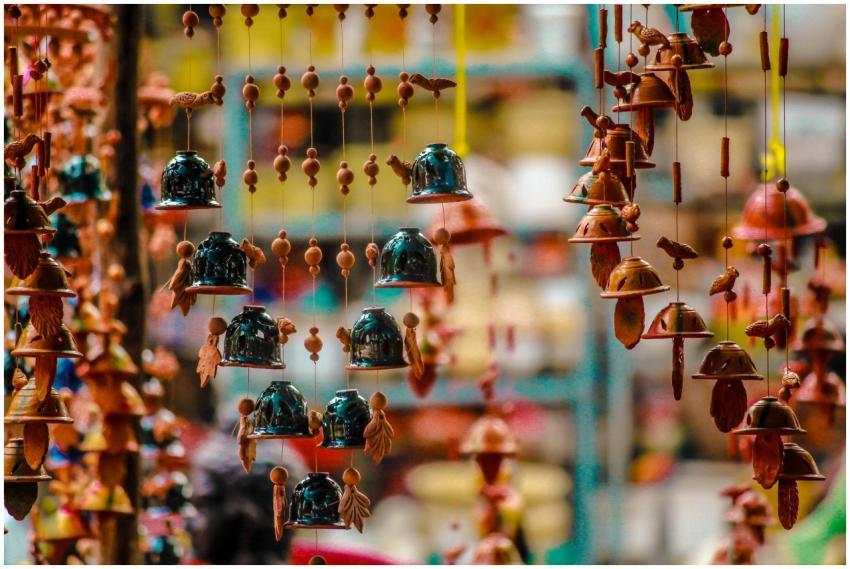 Vibrant hanging bells and ornaments in a pottery m