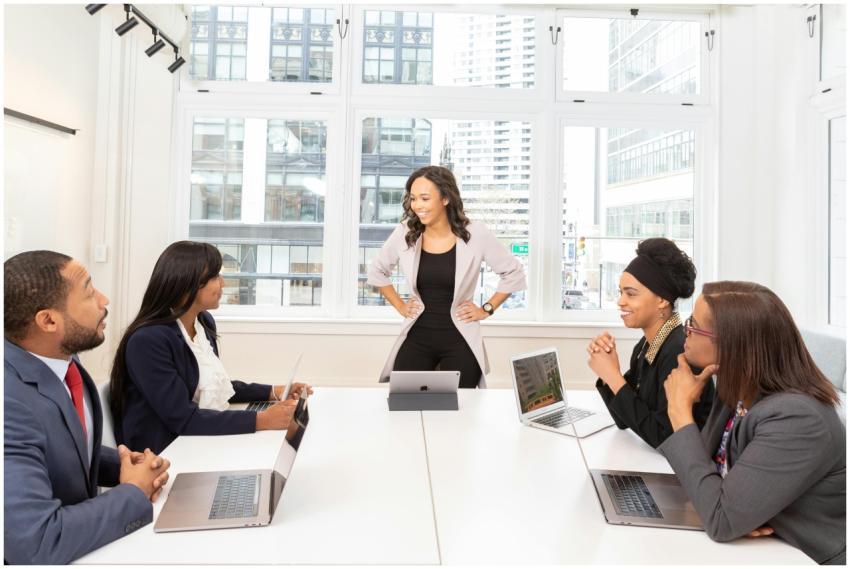 Diverse team engaged in a business meeting with la