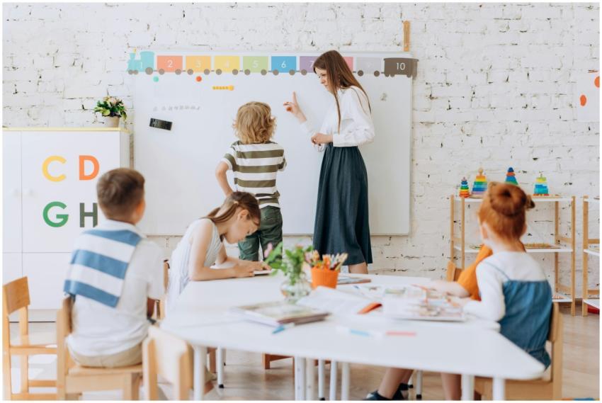 Teacher instructing children in a colorful classro