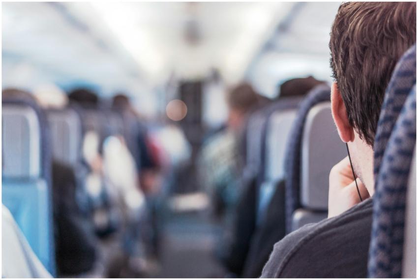 Blurred view of passengers seated on a train, emph