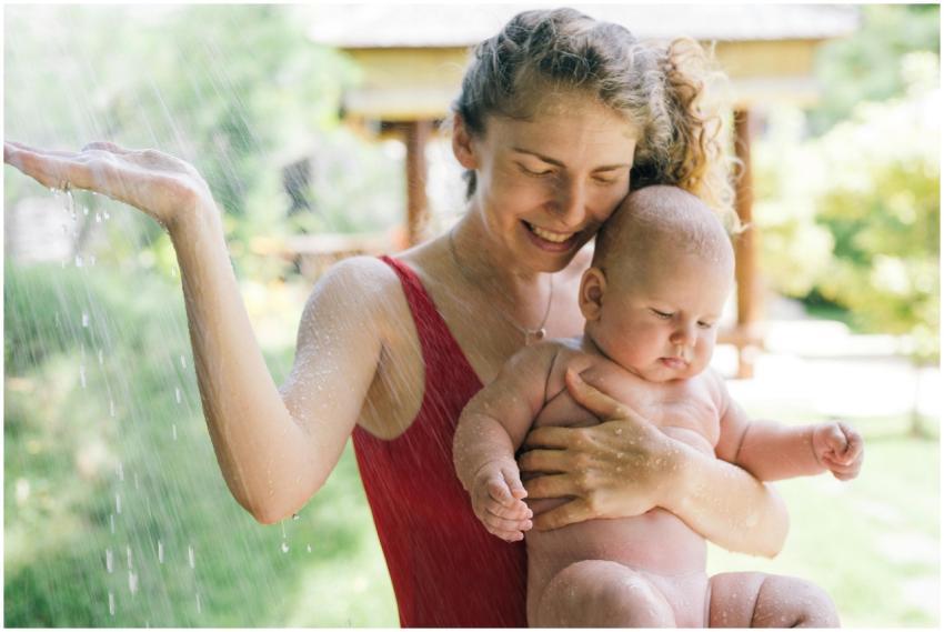 A joyful mother and her baby enjoy an outdoor show