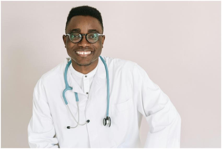 Cheerful male doctor wearing eyeglasses and a stet