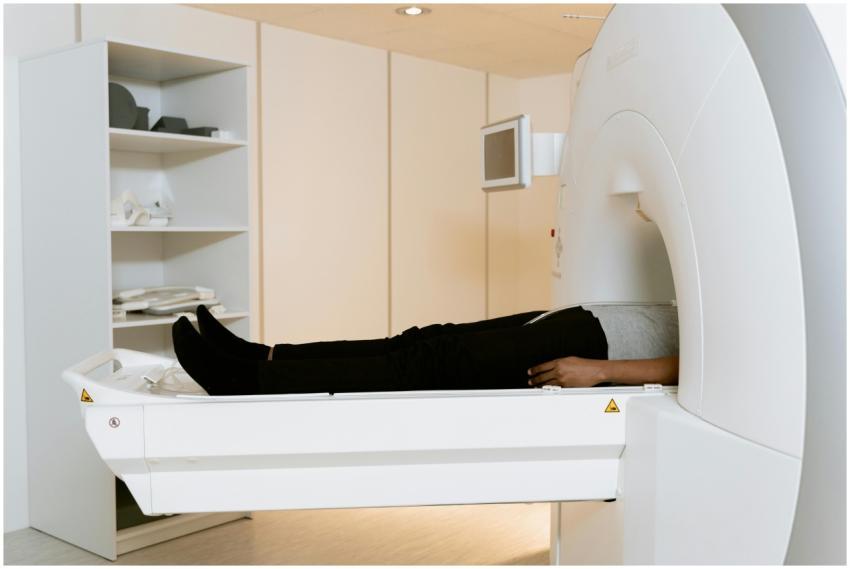 A patient is lying down inside an MRI machine duri