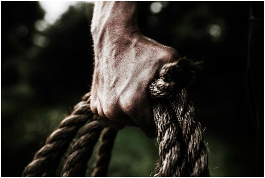 A close-up image shows a strong, firm hand grippin