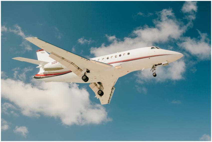 A sleek private jet captured mid-flight against a