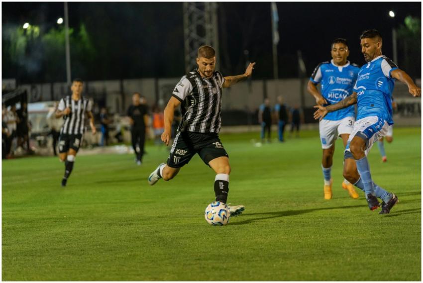 Dynamic soccer game under lights with players batt