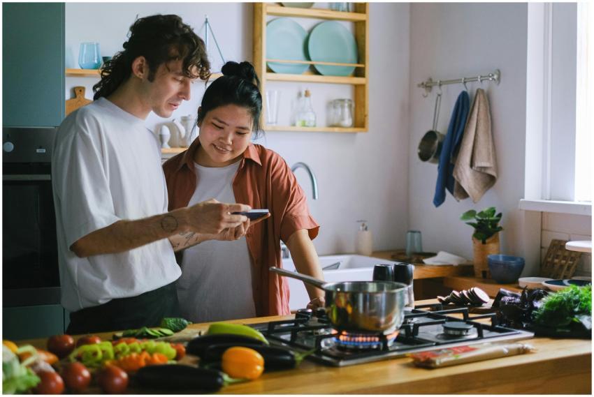 Two people preparing a meal using fresh vegetables