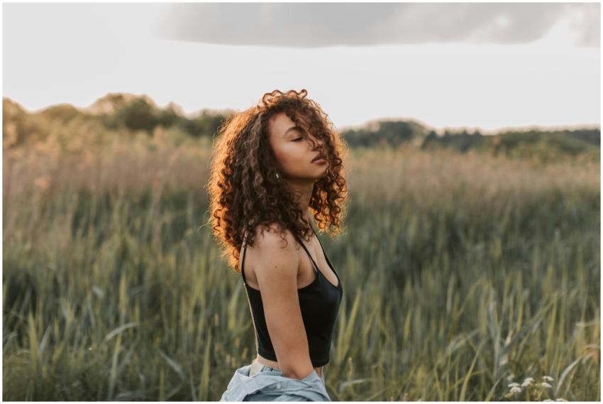 Beautiful woman with curly hair enjoying a summer