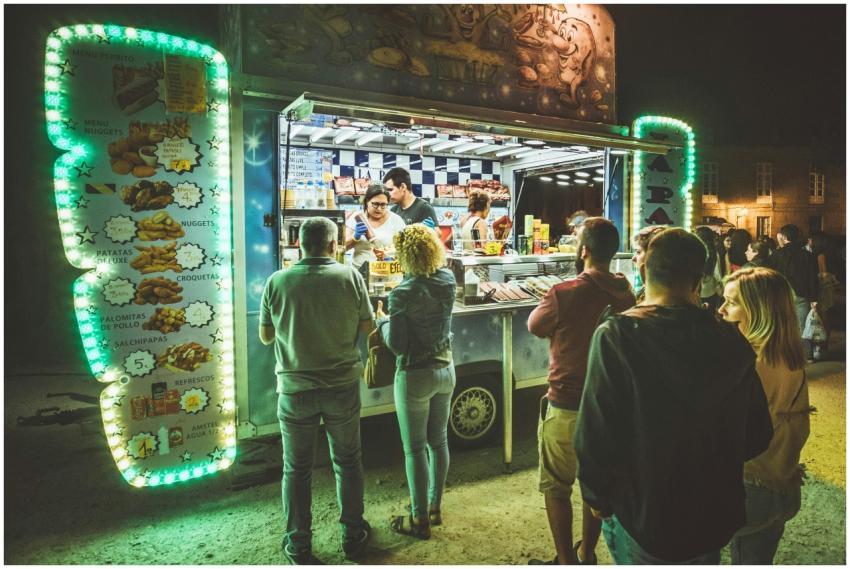 People enjoying vibrant street food at a food truc