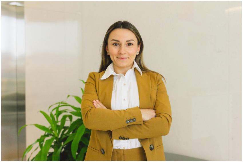 Confident woman in business suit standing indoors