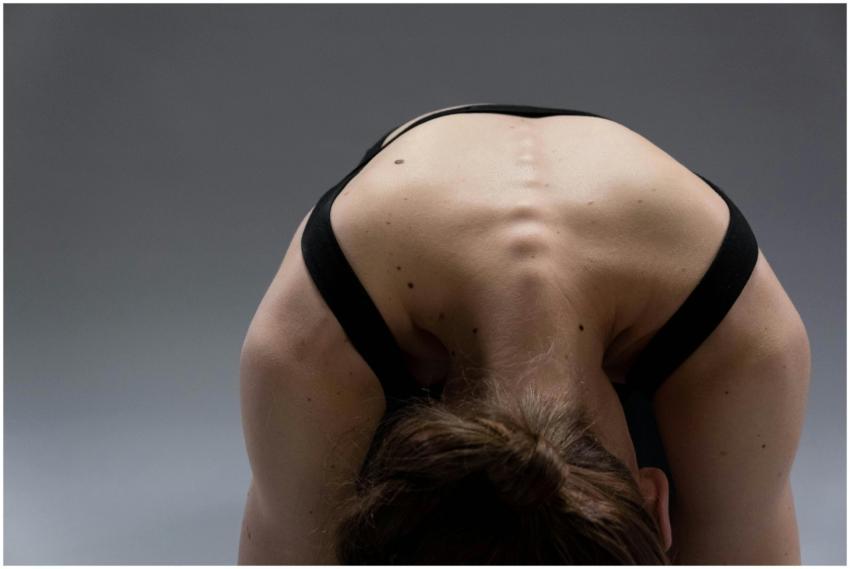A woman performing a yoga pose that highlights her