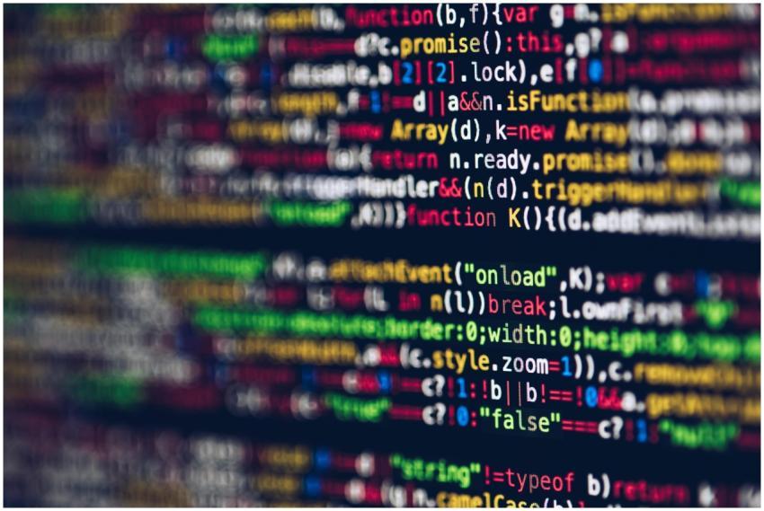 Vivid, blurred close-up of colorful code on a scre