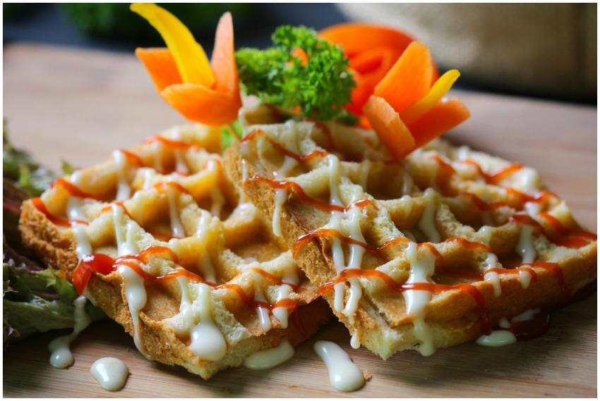 Close-up of crispy waffles drizzled with sauces, g