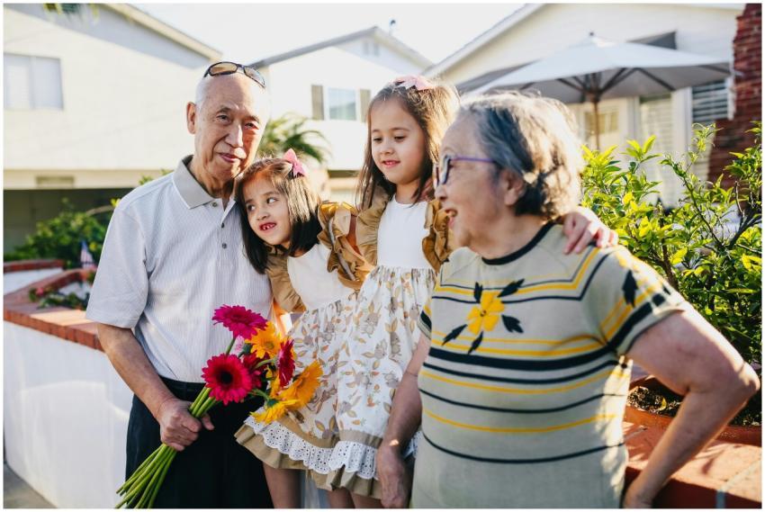 Asian grandparents with twin grandchildren enjoyin