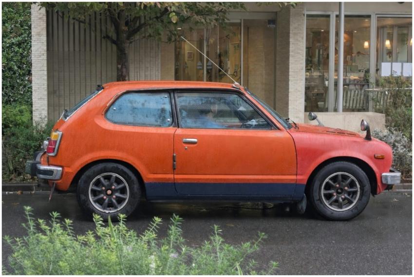 Classic orange hatchback car parked outdoors on a