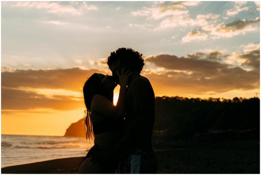 Couple embracing at sunset on a beach in El Salvad