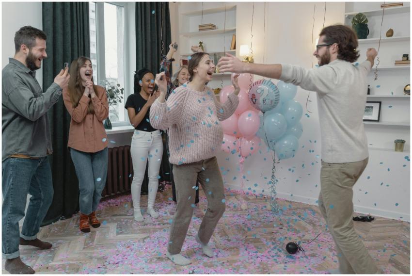 Happy friends celebrate a gender reveal party with