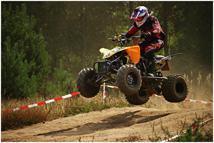 Motorsport rider performs a high-speed ATV jump on