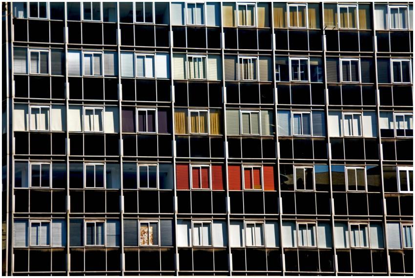 A vibrant facade of a modern apartment building wi