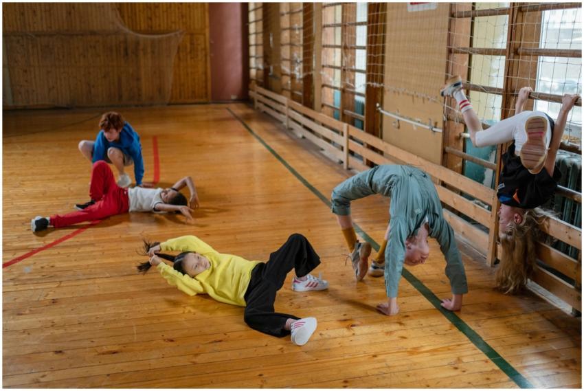Children playing in a gym, engaging in acrobatic e