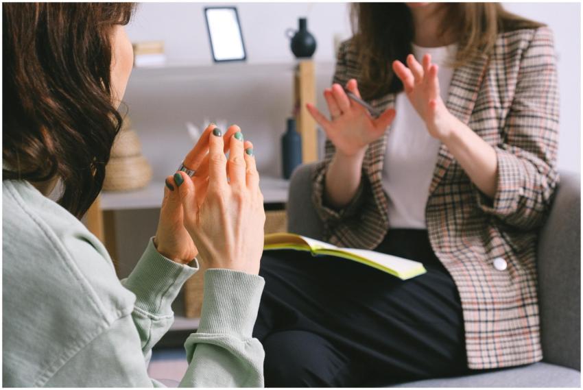 Two women engaged in a therapy session, communicat