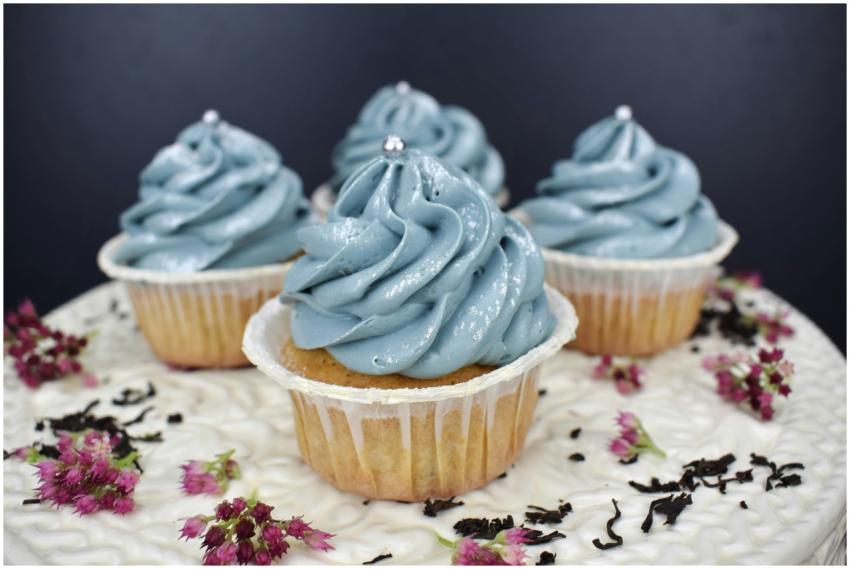 Close-up of blue frosted cupcakes with floral deco