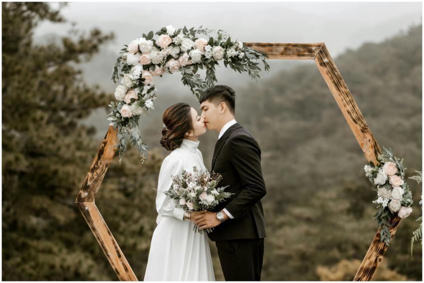 A romantic wedding scene with a couple kissing und