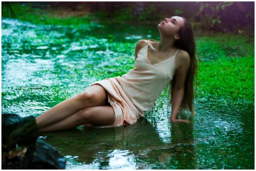 Serene scene of a woman relaxing on grass during a