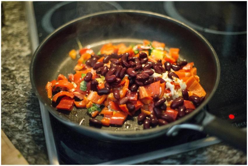 Close-up of bell peppers and beans in a frying pan