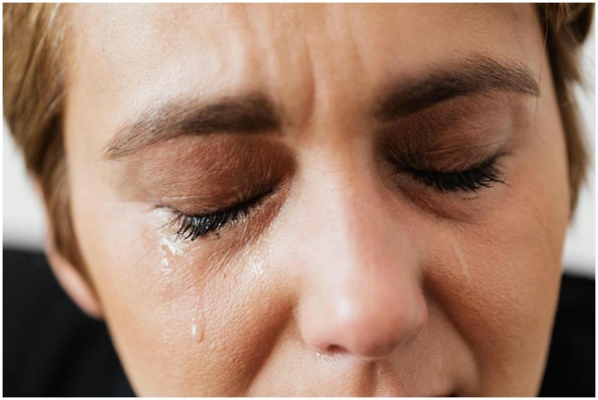 Emotional close-up of a woman's face with closed e