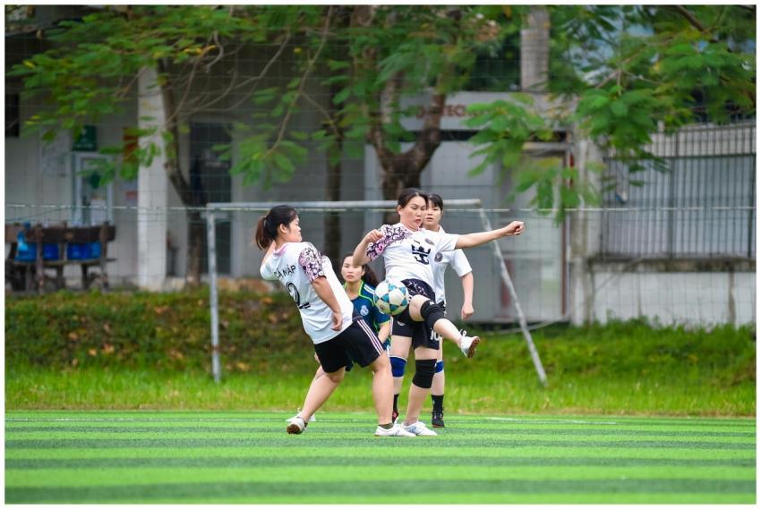 Women's football players in action during an outdo