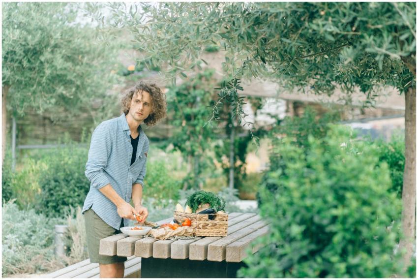 An adult man preparing fresh vegan ingredients at
