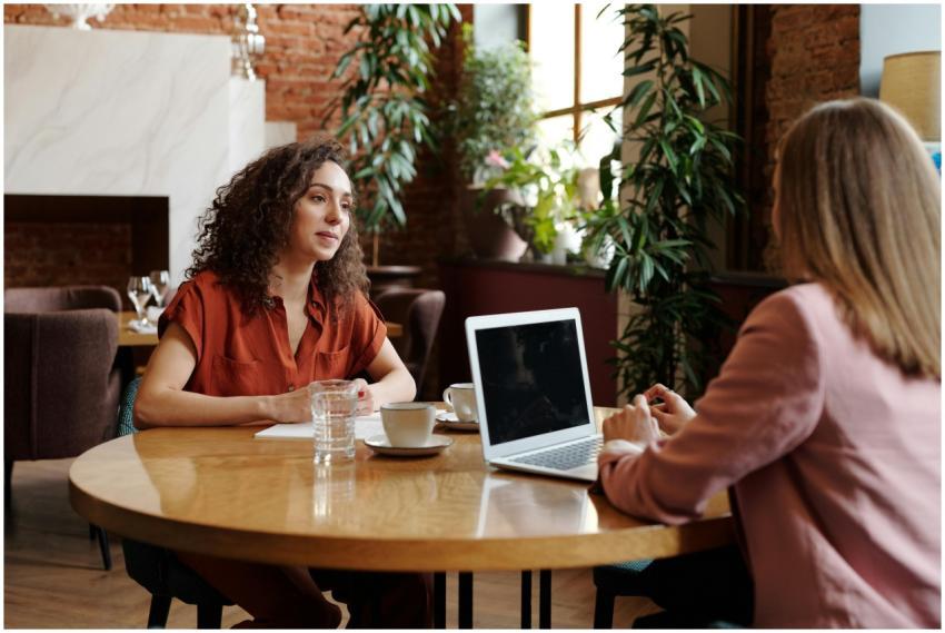 Two businesswomen engage in a meeting at a cozy co