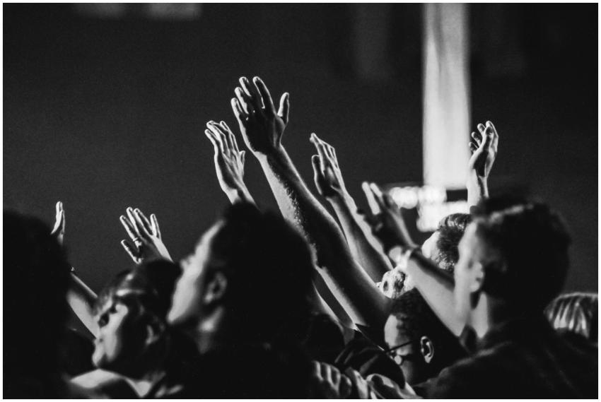Dynamic black and white photo of a concert audienc