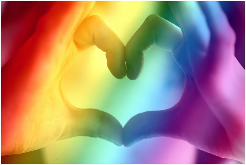 Hands forming a rainbow heart shape, symbolizing l