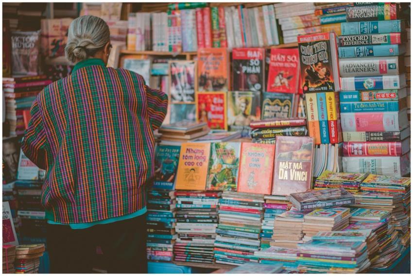 A senior woman in colorful attire browsing a diver
