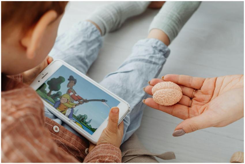 A child watches a cartoon on a smartphone indoors.