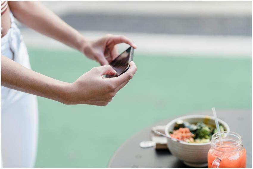 Crop unrecognizable female blogger taking photo of