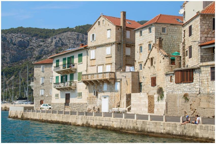 Charming stone buildings along a sunlit Croatian w