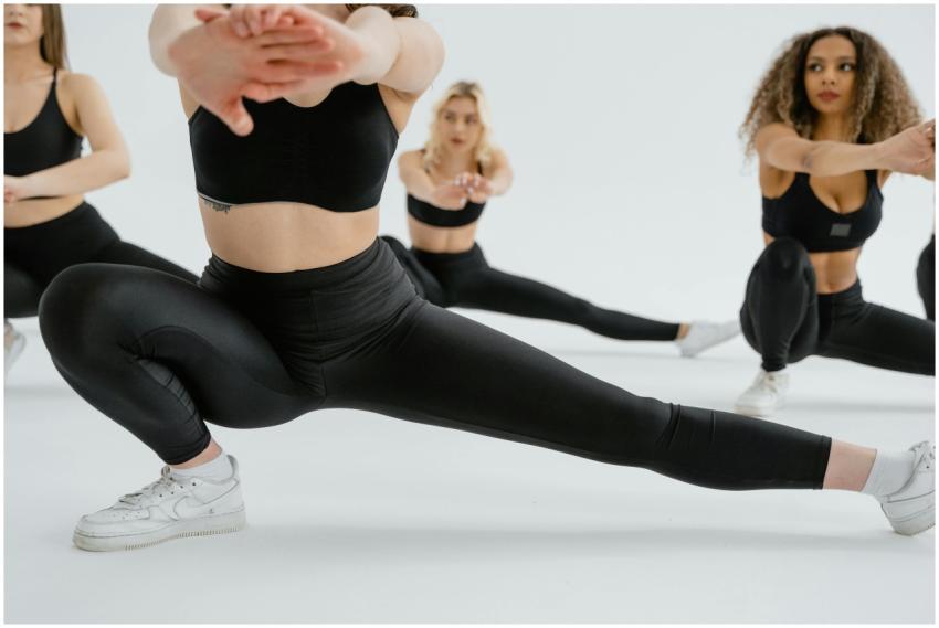 Women in sportswear performing stretching exercise