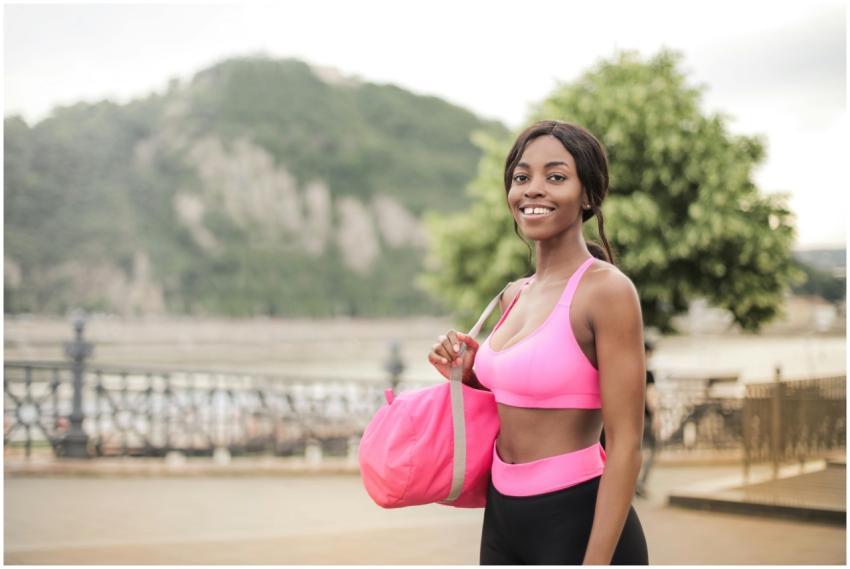 A cheerful woman enjoying outdoor fitness with a d