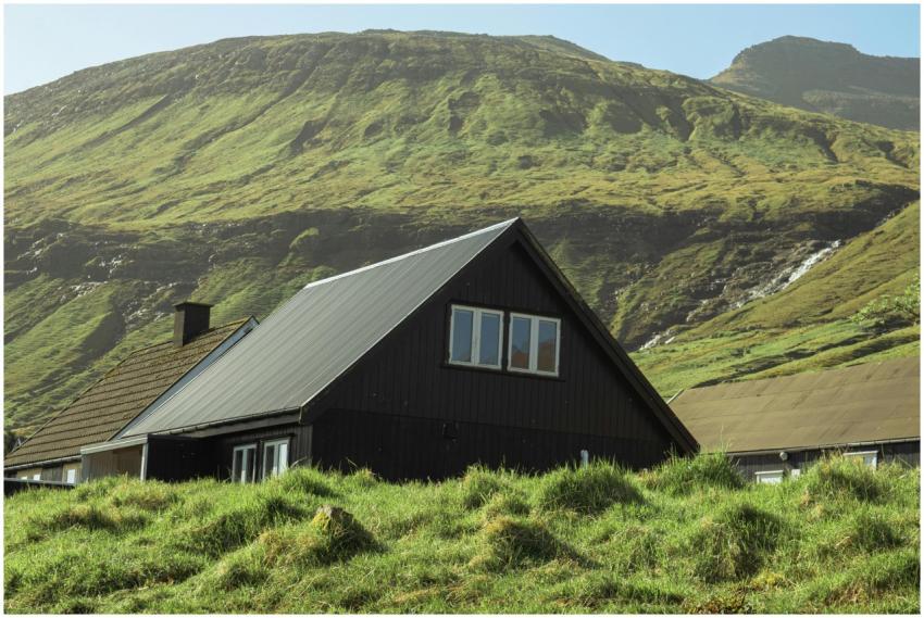 Charming black cottage nestled in lush green hills