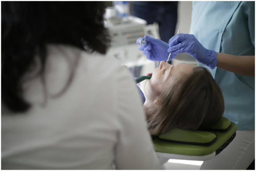 Dentist examines patient in a clinic setting with