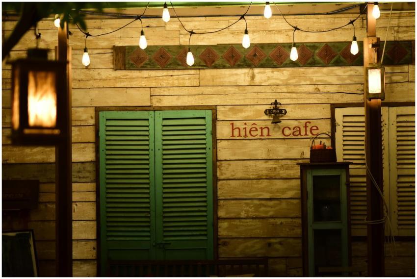 Warmly lit vintage cafe facade with hanging lights