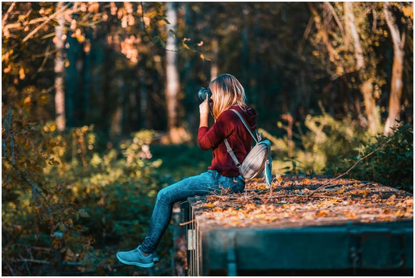 Young woman takes photos in a vibrant forest setti