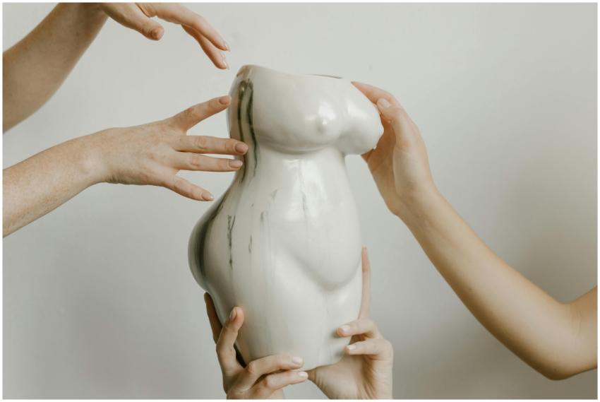 Hands gently holding and interacting with a unique